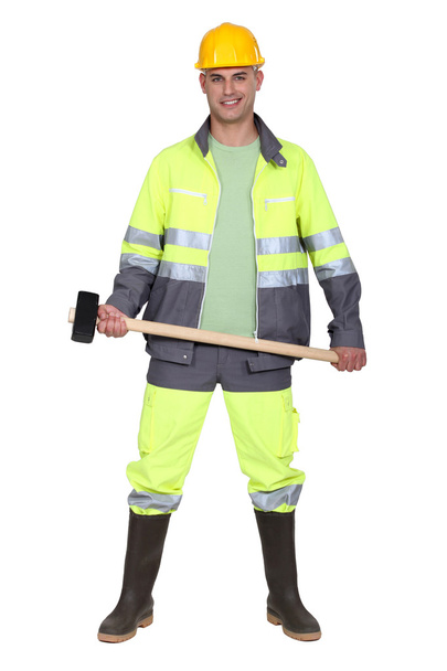 Tradesman holding a mallet - Foto, Imagen