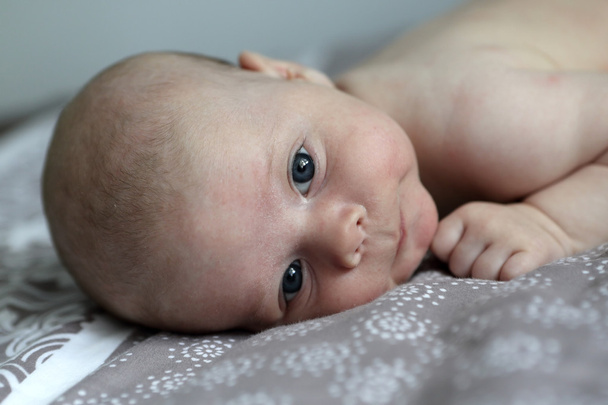 Pensive baby boy on a bed - Photo, Image