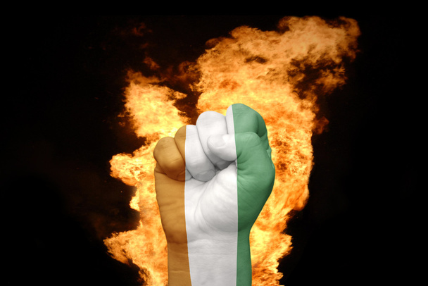 fire fist with the national flag of cote divoire - Photo, Image