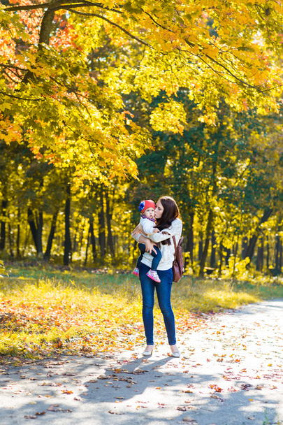 happy family mother with child little daughter running and playing on autumn park - 写真・画像