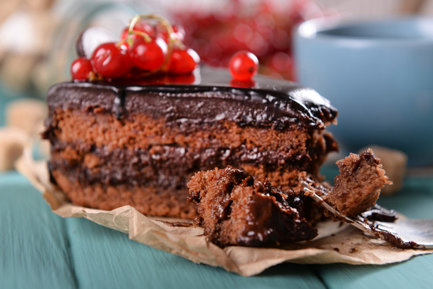 Tasty chocolate cake with berries and cup of tea on table close up - Фото, зображення