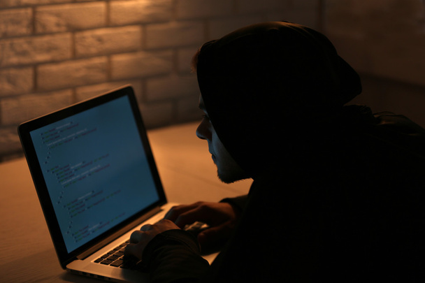 Hacker with laptop - Фото, зображення