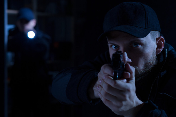 Officer pointing gun at criminal - Fotó, kép