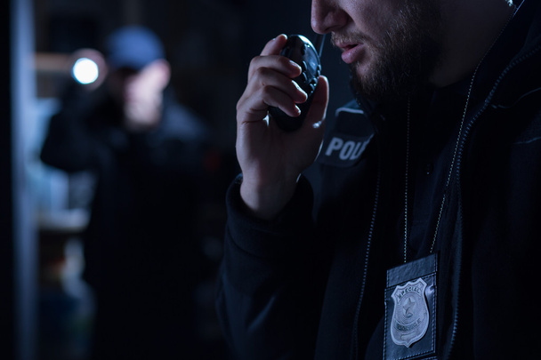 Officer using walkie talkie - Фото, изображение