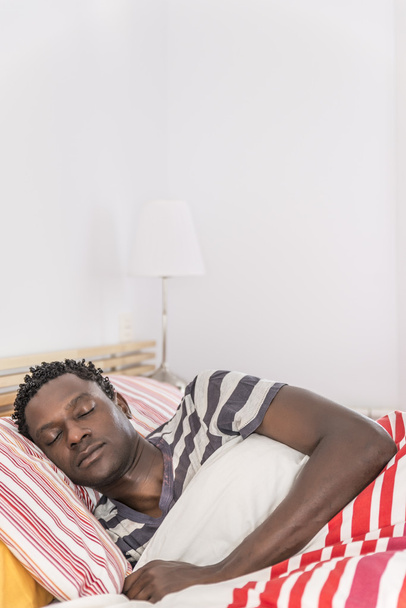 Peaceful african black man sleeping in bed - Foto, Imagen