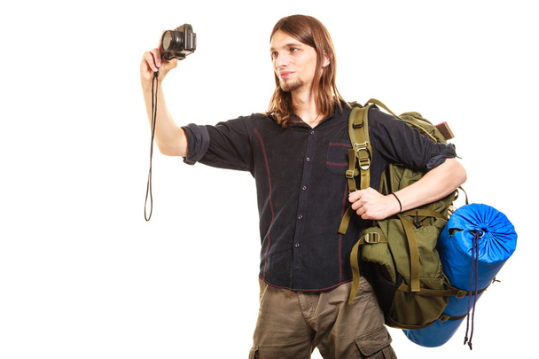 Man tourist backpacker taking photo with camera. - Fotografie, Obrázek