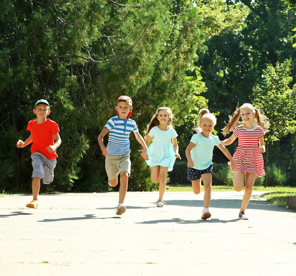 Happy active children running in park - Foto, afbeelding
