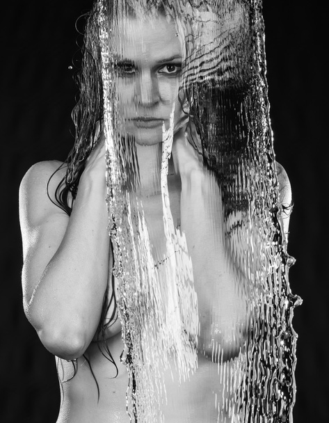 Nude Woman Behind Stream of Falling Water - Foto, afbeelding