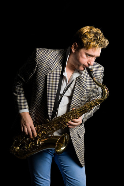 Musician plays the saxophone. - Zdjęcie, obraz