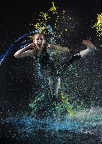 Woman High Kicking in Colorful Water Splashes - Fotó, kép
