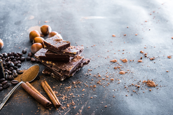 Chocolate, nuts, spices on table - Fotoğraf, Görsel
