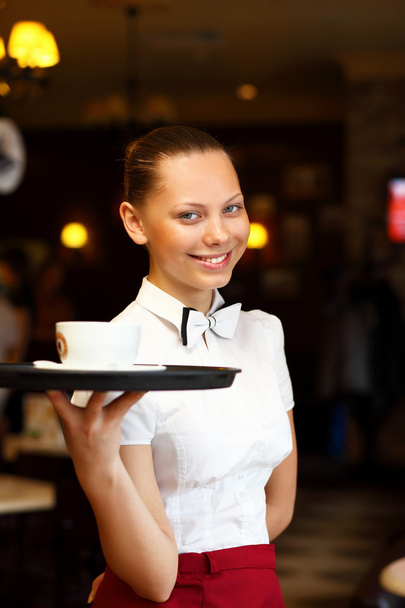 Portrait of young waitress holding a tray - Photo, Image