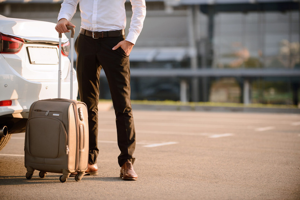 Nice businessman holding suitcase - Фото, зображення