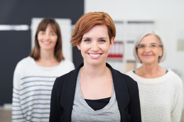 Smiling Office Woman Against Two Colleagues - Foto, imagen