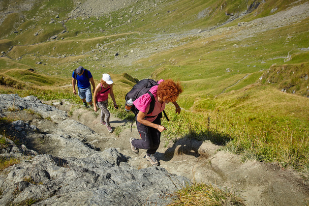 hikers on a steep trail in the mountains - Valokuva, kuva