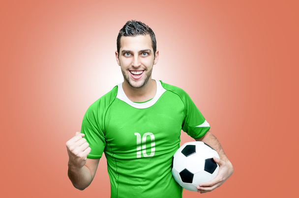 Футбольний фанат святкує в зеленій футболці
 - Фото, зображення