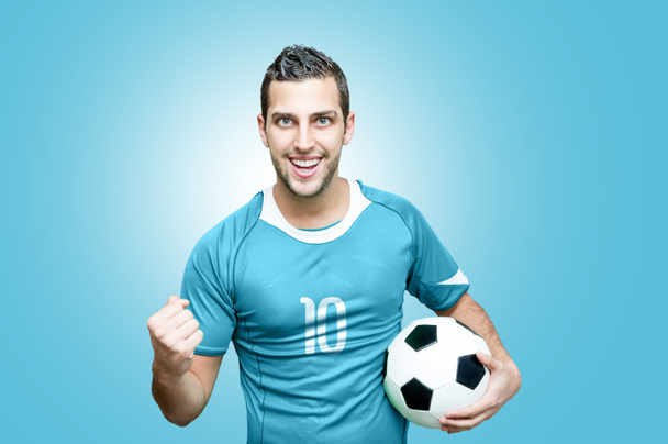 Футбольний фанат святкує в синій футболці
 - Фото, зображення