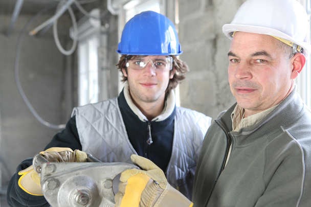Construction worker and young helper - Foto, imagen