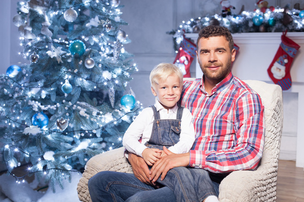 Attractive young man is celebrating Christmas with son - Fotoğraf, Görsel