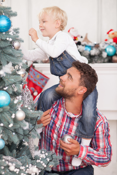 Cheerful friendly family is preparing for Christmas - 写真・画像
