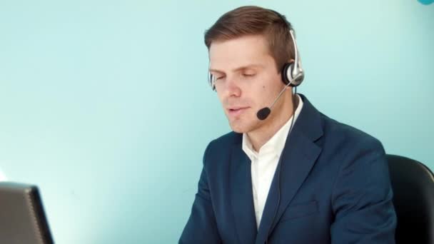 Man in call center smilingly looking at the camera - Footage, Video