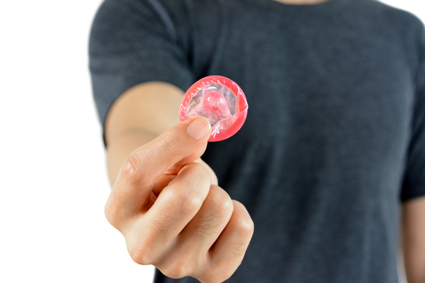 Young man giving condom - Fotó, kép