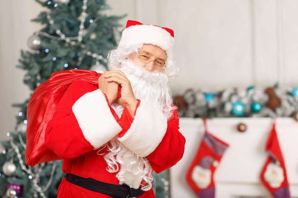 Santa Claus holding Christmas bag - Photo, Image