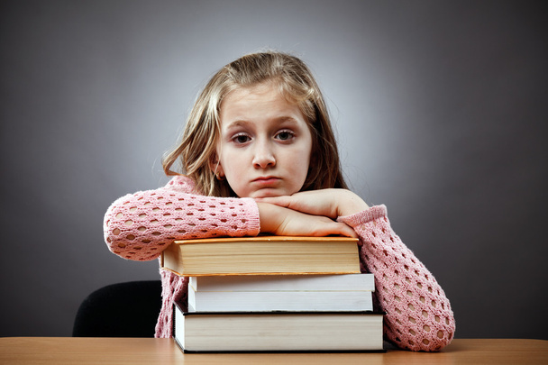 Unhappy schoolgirl with a stack of books - Foto, immagini