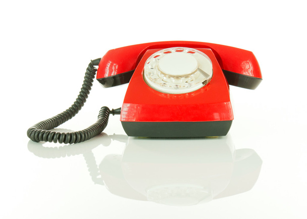 Rojo teléfono anticuado contra fondo blanco
 - Foto, Imagen