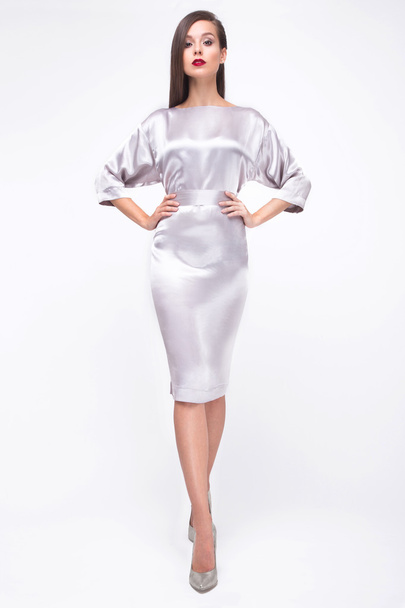 Pretty girl in fashionable stylish clothes, walking on a white background. Beauty, fashion, style. - Valokuva, kuva