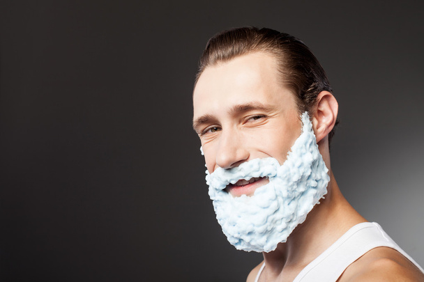 Attractive bearded young hipster guy is ready to shave - Fotó, kép