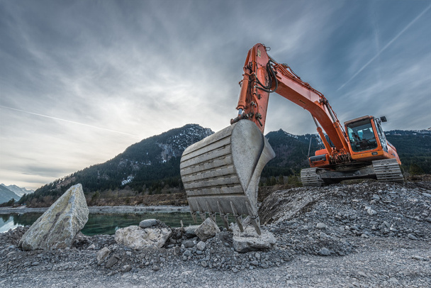 big orange digger on gravel heap with big shovel - Photo, Image