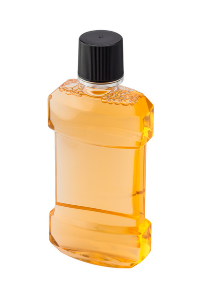 Plastic bottle of mint orange mouthwash isolated on white backgr - 写真・画像