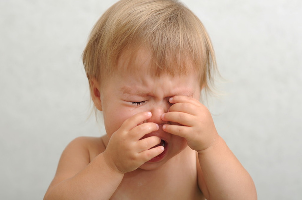 crying baby rubbing her eyes - Fotó, kép