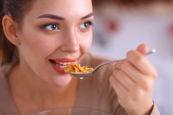 A young woman trying cereals in her kitchen - Foto, Bild