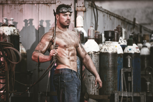 Muscular man with an acetylene burner - Zdjęcie, obraz