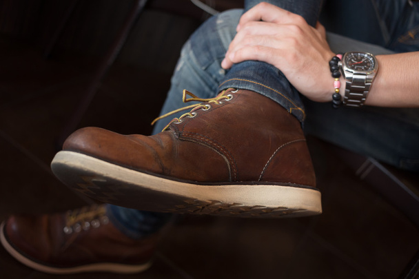 коричневые сапоги кожаные туфли и джинсовые брюки одежда человека
 - Фото, изображение