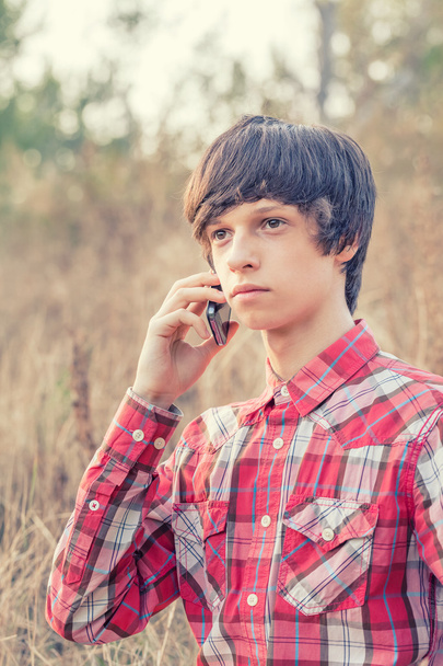 young student talking on mobile phone in a city park - Foto, Imagem