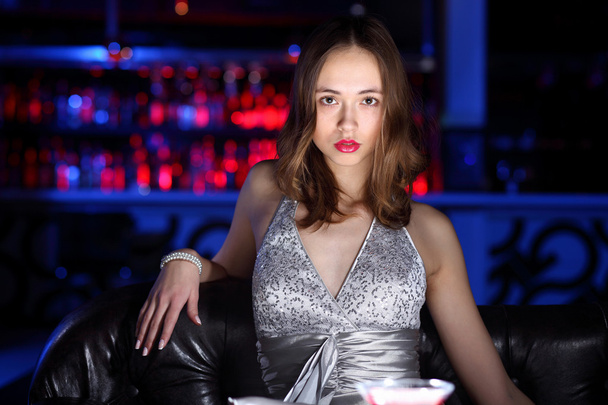 Young woman in night club with a drink - Fotografie, Obrázek