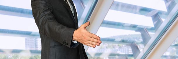 Businessman in suit giving hand for handshake - Foto, Imagen