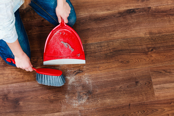 eaning woman sweeping wooden floor - Фото, изображение