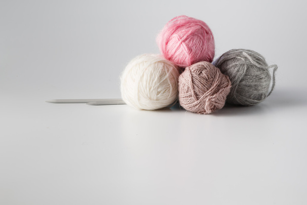 Clews of colored yarn with needle - 写真・画像