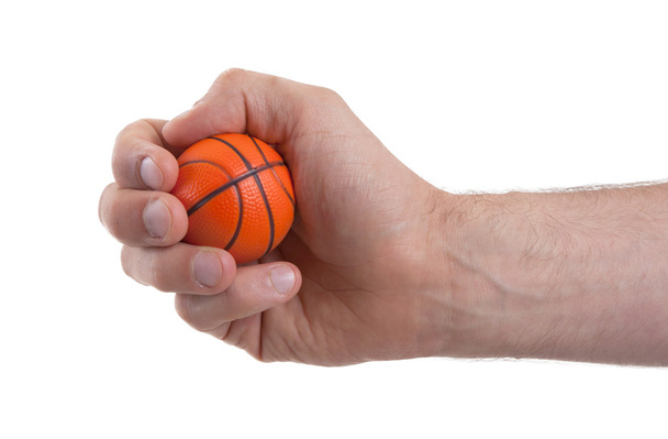 Isolated hand with a mini basket ball - 写真・画像
