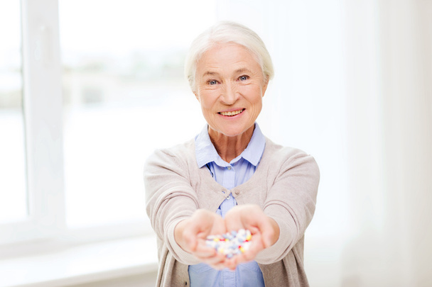 happy senior woman with medicine at home - Фото, зображення