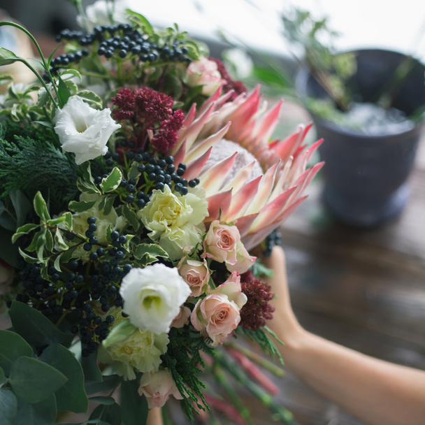 Florist workplace: flowers and accessories on a vintage wooden table. soft focus - Valokuva, kuva