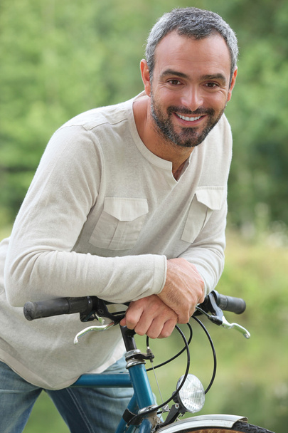 Man on bike ride - Фото, изображение