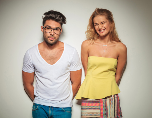 muscular man posing with glasses while girl is laughing - Foto, Imagem