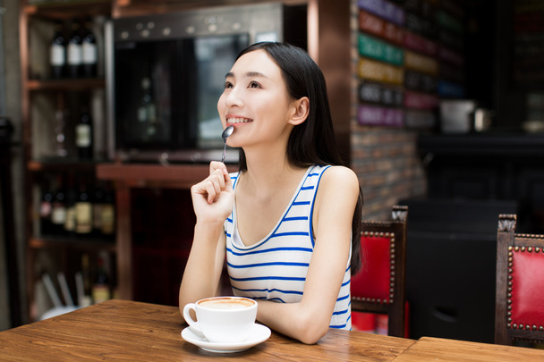 young girl drinking coffee during the break - Photo, image