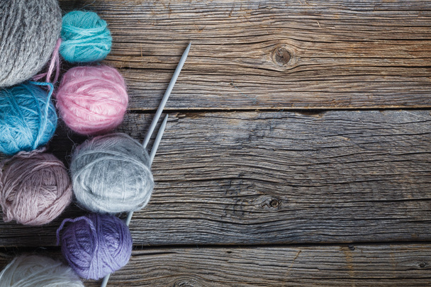 Clews of colored yarn with needle - Zdjęcie, obraz