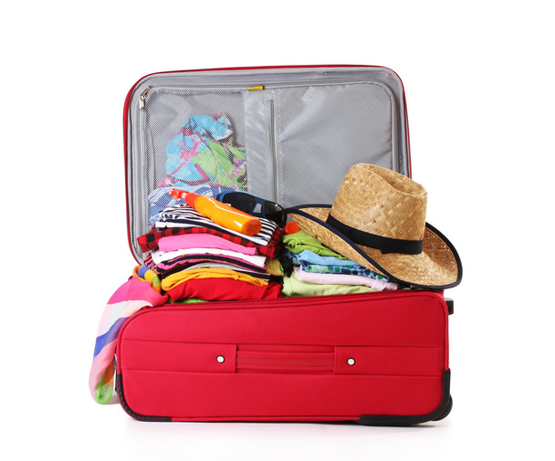 Open red suitcase with clothing isolated on a white - Photo, image